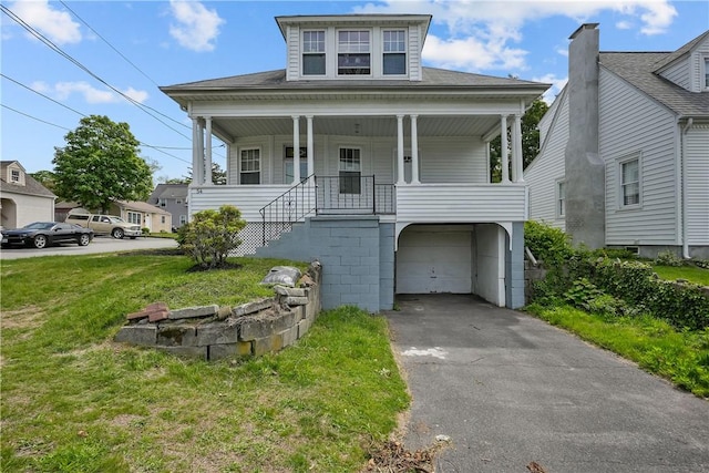 54 Delway Rd, East Providence, RI 02914 - view of front facade featuring an attached garage, a front yard, asphalt driveway, and covered porch