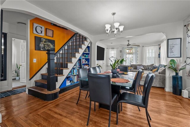 54 Delway Rd, East Providence, RI 02914 - dining space with arched walkways, stairs, a ceiling fan, and a chandelier