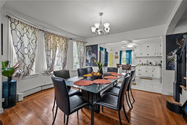 54 Delway Rd, East Providence, RI 02914 - dining area with baseboard heating, a chandelier, a ceiling fan, and plenty of natural light