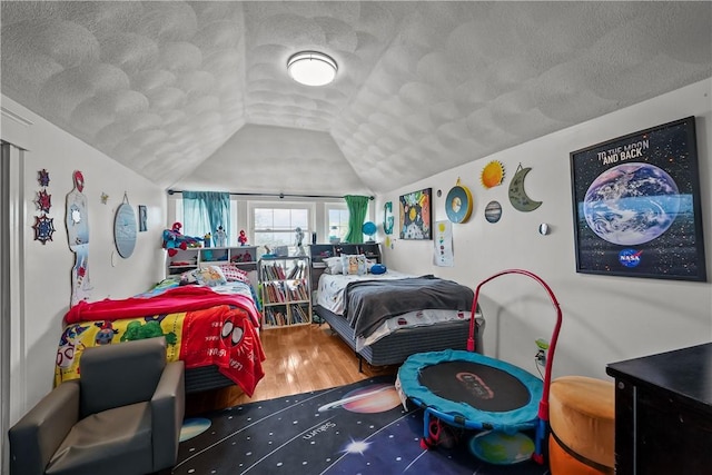 54 Delway Rd, East Providence, RI 02914 - bedroom featuring a textured ceiling, vaulted ceiling, and wood finished floors