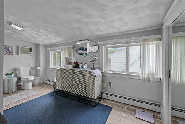 54 Delway Rd, East Providence, RI 02914 - interior space featuring wood finished floors, a wall mounted air conditioner, vaulted ceiling, and a baseboard heating unit