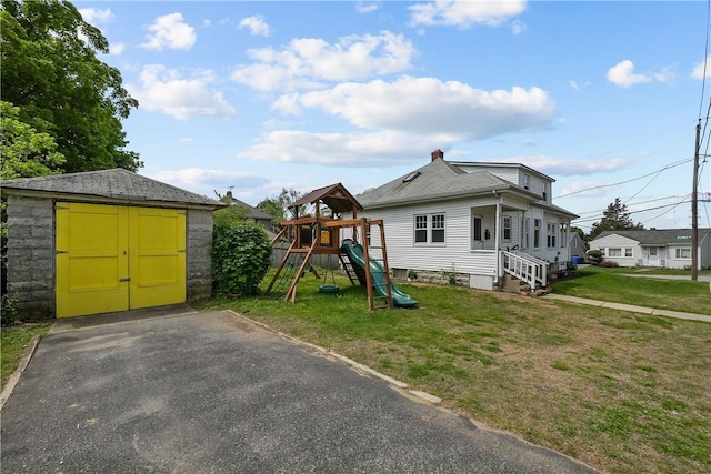 54 Delway Rd, East Providence, RI 02914 - view of front facade featuring a storage unit, a front lawn, an outdoor structure, and a playground