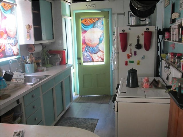 0 Beach Rd, Portsmouth, RI 02871 - kitchen featuring freestanding refrigerator, a sink, light countertops, washer / dryer, and wood finished floors