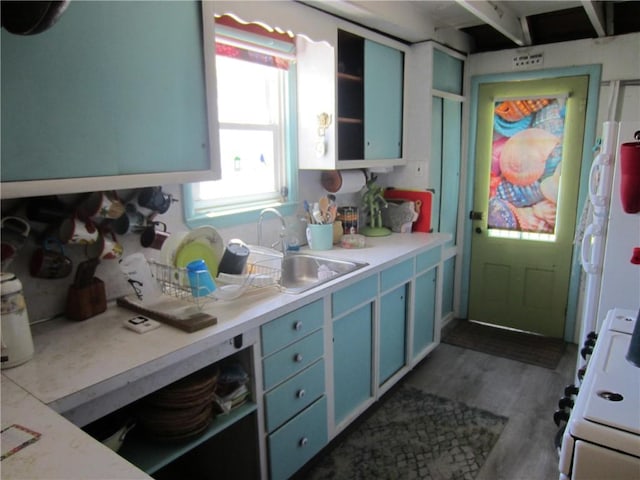 0 Beach Rd, Portsmouth, RI 02871 - kitchen with blue cabinets, white stove, a sink, light countertops, and dark wood-style floors