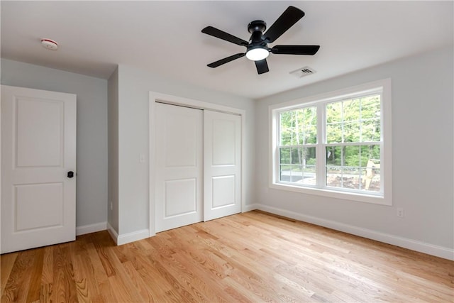 300 Tower Hill Rd, Cumberland, RI 02864 - unfurnished bedroom with baseboards, light wood-type flooring, a closet, and a ceiling fan