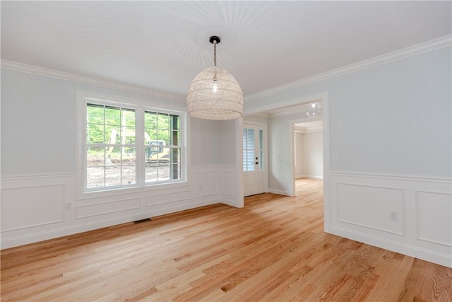 300 Tower Hill Rd, Cumberland, RI 02864 - empty room with crown molding, light wood-style flooring, a decorative wall, and wainscoting