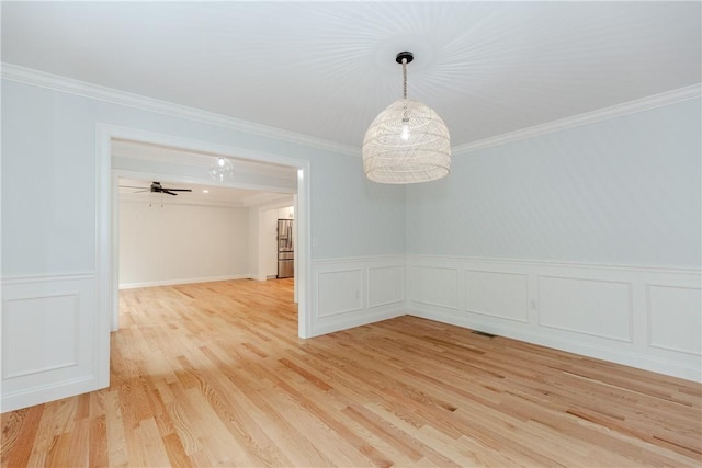 300 Tower Hill Rd, Cumberland, RI 02864 - spare room featuring crown molding, light wood-style floors, a decorative wall, and a wainscoted wall