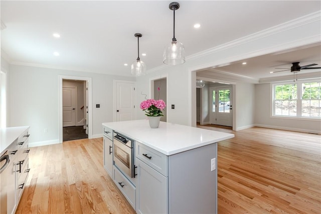 300 Tower Hill Rd, Cumberland, RI 02864 - kitchen featuring ornamental molding, light wood-type flooring, a kitchen island, light countertops, and baseboards