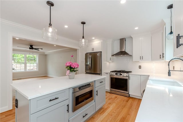 300 Tower Hill Rd, Cumberland, RI 02864 - kitchen with wall chimney exhaust hood, stainless steel appliances, a sink, light wood-type flooring, and ornamental molding