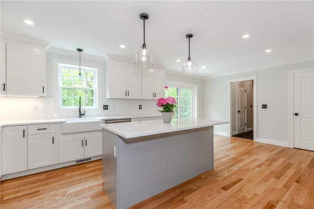 300 Tower Hill Rd, Cumberland, RI 02864 - kitchen featuring a sink, light countertops, decorative backsplash, white cabinetry, and crown molding