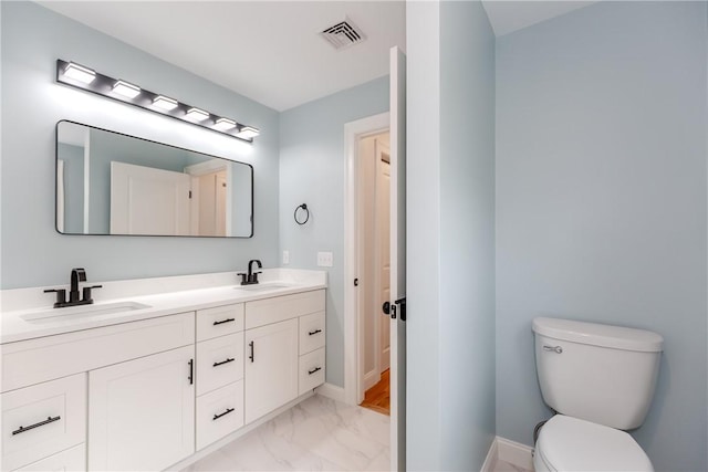 300 Tower Hill Rd, Cumberland, RI 02864 - bathroom featuring marble look tiles, double vanity, baseboards, and toilet