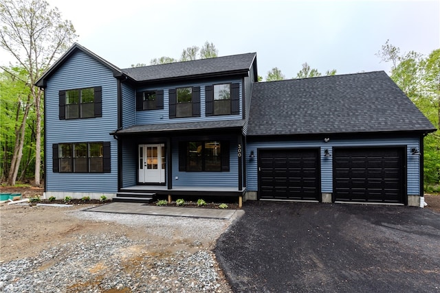 300 Tower Hill Rd, Cumberland, RI 02864 - view of front of house featuring a garage, asphalt driveway, covered porch, and a shingled roof