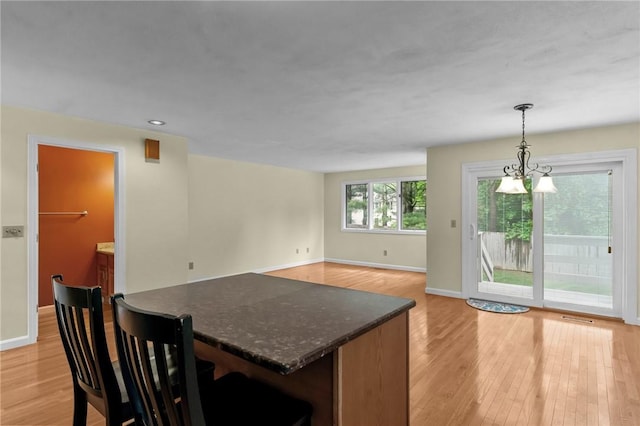 kitchen with light wood-style floors, baseboards, hanging light fixtures, and recessed lighting
