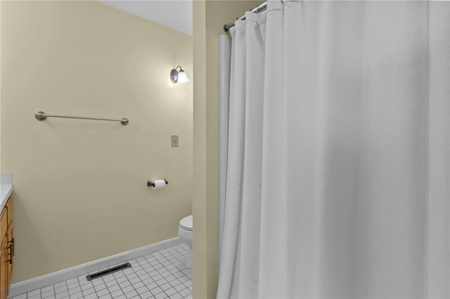 full bathroom featuring tile patterned flooring, baseboards, toilet, and vanity