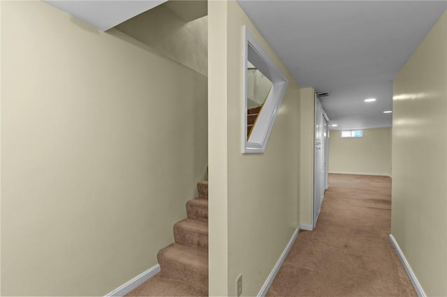 hall with carpet flooring, baseboards, stairs, and recessed lighting