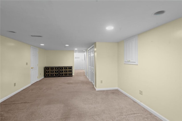 finished below grade area featuring carpet flooring, baseboards, and recessed lighting
