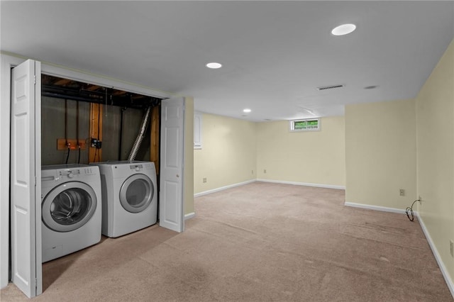laundry room with washer and dryer, light colored carpet, baseboards, and recessed lighting