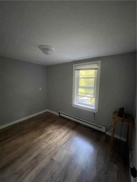 8 Aldrich St, Hopkinton, RI 02898 - empty room with a baseboard radiator, dark wood-style floors, and baseboards