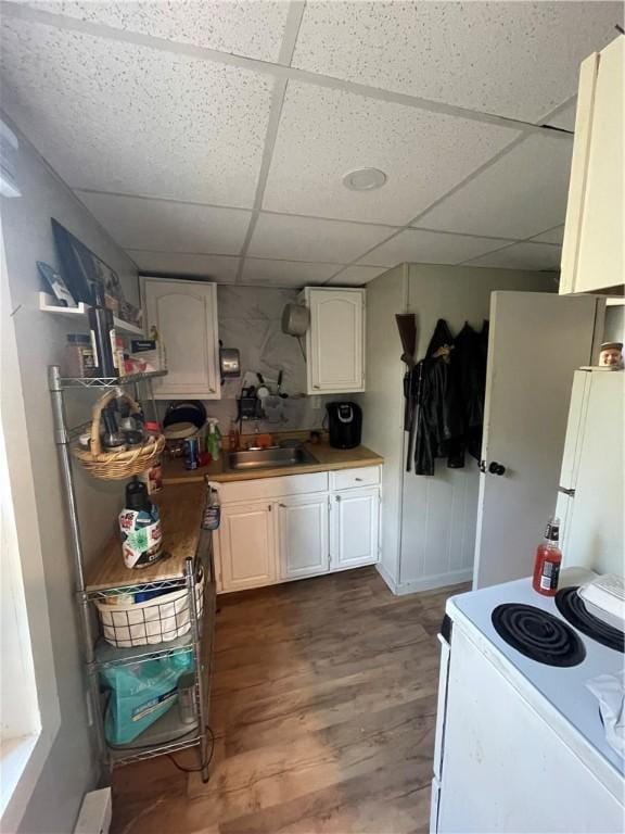 8 Aldrich St, Hopkinton, RI 02898 - kitchen with white appliances, a drop ceiling, wood finished floors, white cabinets, and a sink