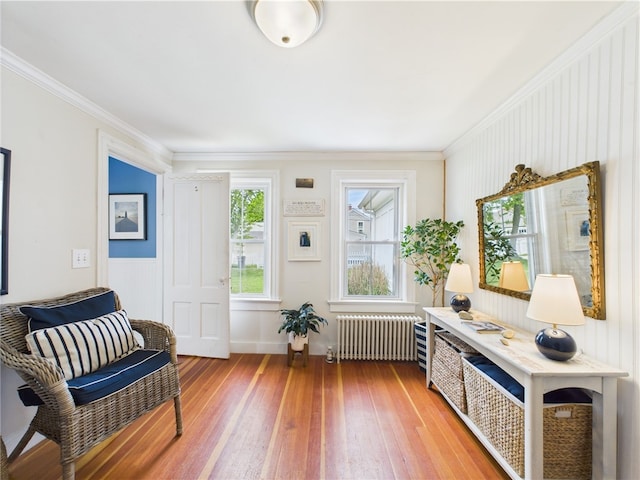39 Union St, East Greenwich, RI 02818 - sitting room featuring radiator heating unit, light wood-style floors, and ornamental molding