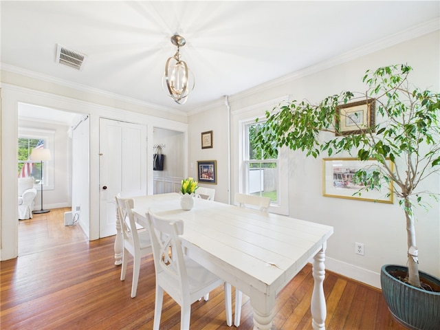 39 Union St, East Greenwich, RI 02818 - dining space featuring a chandelier, wood finished floors, baseboards, and crown molding