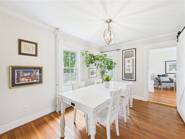 39 Union St, East Greenwich, RI 02818 - dining area featuring a chandelier, wood finished floors, baseboards, and ornamental molding