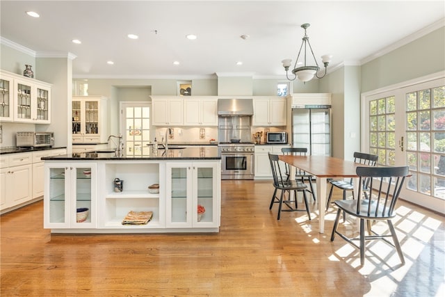 3 Stone Tower Ln, Barrington, RI 02806 - kitchen with appliances with stainless steel finishes, dark countertops, wall chimney range hood, light wood finished floors, and recessed lighting