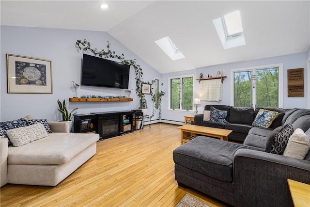 31 Corey Trl, Richmond, RI 02898 - living room featuring a skylight, vaulted ceiling, wood-type flooring, and a glass covered fireplace