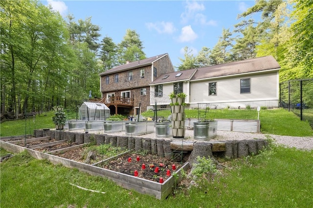 31 Corey Trl, Richmond, RI 02898 - rear view of house featuring a greenhouse, a garden, and an outbuilding