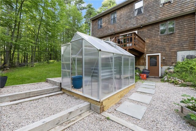 31 Corey Trl, Richmond, RI 02898 - back of property featuring a greenhouse, an outbuilding, and a wooden deck