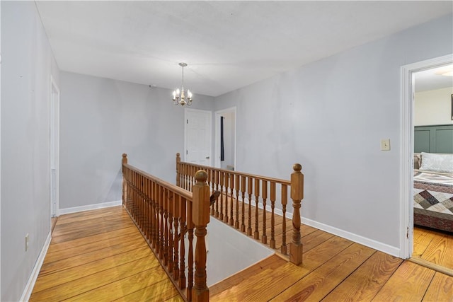 31 Corey Trl, Richmond, RI 02898 - hall featuring an upstairs landing, light wood-style floors, a chandelier, and baseboards