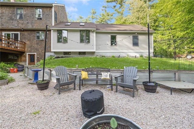 31 Corey Trl, Richmond, RI 02898 - back of property featuring an outdoor fire pit and a yard