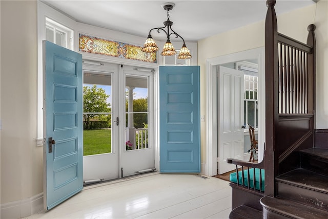 125 Sakonnet Point Rd, Little Compton, RI 02837 - entrance foyer featuring plenty of natural light, wood finished floors, and a chandelier