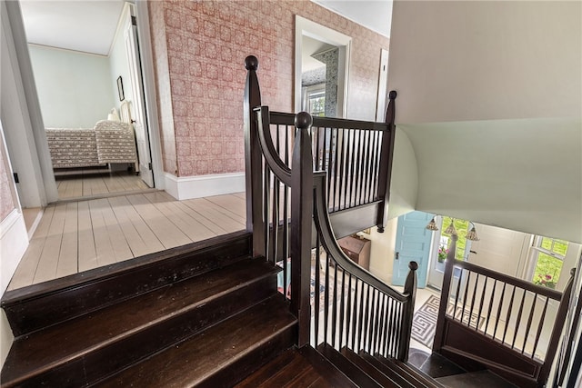 125 Sakonnet Point Rd, Little Compton, RI 02837 - stairway featuring wallpapered walls, baseboards, and hardwood / wood-style flooring