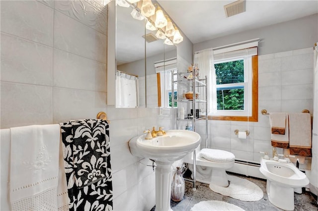 bathroom featuring tile walls, a baseboard radiator, toilet, and a bidet