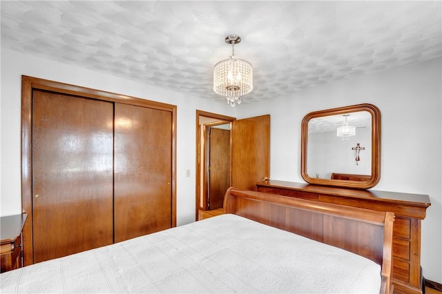 bedroom featuring a chandelier and a closet