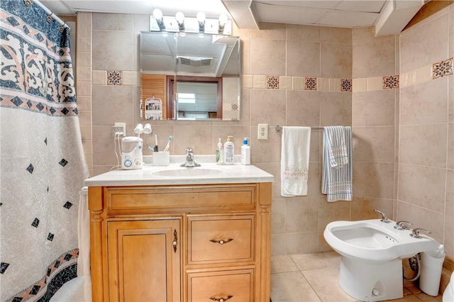 full bath featuring tile walls, a bidet, vanity, and tile patterned floors