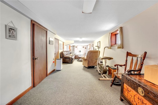 hall featuring carpet floors and baseboards