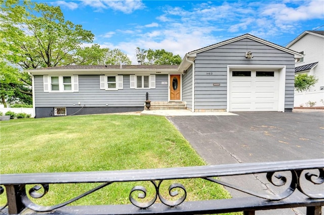 ranch-style house with driveway, an attached garage, a front yard, and entry steps