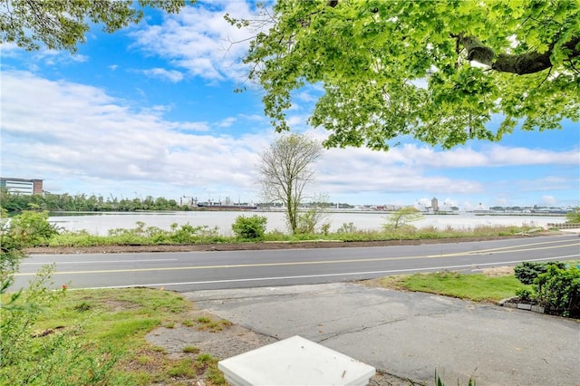 view of asphalt street with a water view