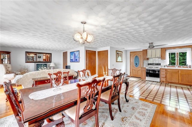 dining space featuring a chandelier and light wood finished floors