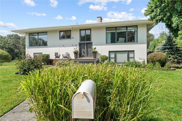 96 Roger Williams Dr, North Kingstown, RI 02852 - view of front of property featuring a front yard and a chimney