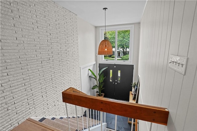 96 Roger Williams Dr, North Kingstown, RI 02852 - staircase featuring brick wall and wood walls