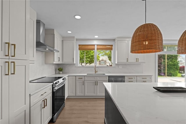 96 Roger Williams Dr, North Kingstown, RI 02852 - kitchen with wall chimney exhaust hood, stainless steel appliances, a sink, light wood-style floors, and backsplash