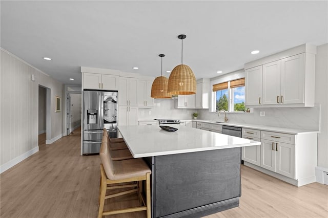 96 Roger Williams Dr, North Kingstown, RI 02852 - kitchen featuring stainless steel appliances, light wood-style flooring, a sink, a center island, and recessed lighting