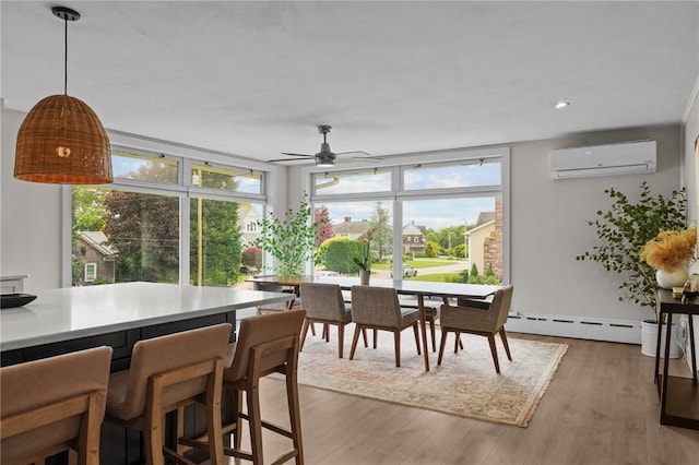 96 Roger Williams Dr, North Kingstown, RI 02852 - dining space with a wall mounted AC, baseboard heating, wood finished floors, and a ceiling fan