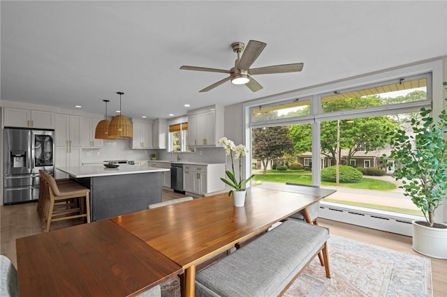 96 Roger Williams Dr, North Kingstown, RI 02852 - dining room featuring light wood-type flooring, a ceiling fan, recessed lighting, and a baseboard radiator
