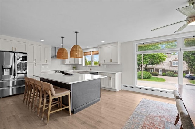 96 Roger Williams Dr, North Kingstown, RI 02852 - kitchen with appliances with stainless steel finishes, a baseboard radiator, light countertops, light wood-style floors, and recessed lighting