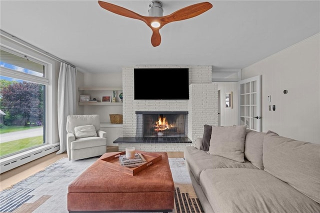 96 Roger Williams Dr, North Kingstown, RI 02852 - living area with a fireplace, a baseboard heating unit, ceiling fan, and wood finished floors