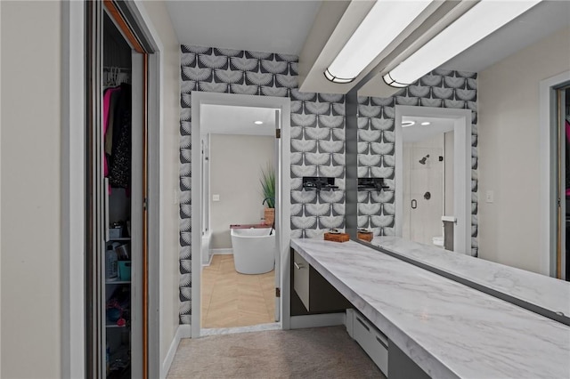 96 Roger Williams Dr, North Kingstown, RI 02852 - bathroom featuring a walk in closet, vanity, a shower, baseboards, and recessed lighting
